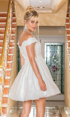A woman stands on a staircase, looking over her shoulder in the Off-the-Shoulder Short Pastel Hoco Dress 3292, featuring delicate lace details.