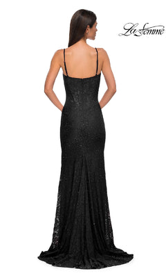 Woman in a black Long Beaded-Lace Prom Dress (La Femme 32933) with thin straps and subtle sparkle, standing with her back to the camera. "La Femme" logo in the top right corner.