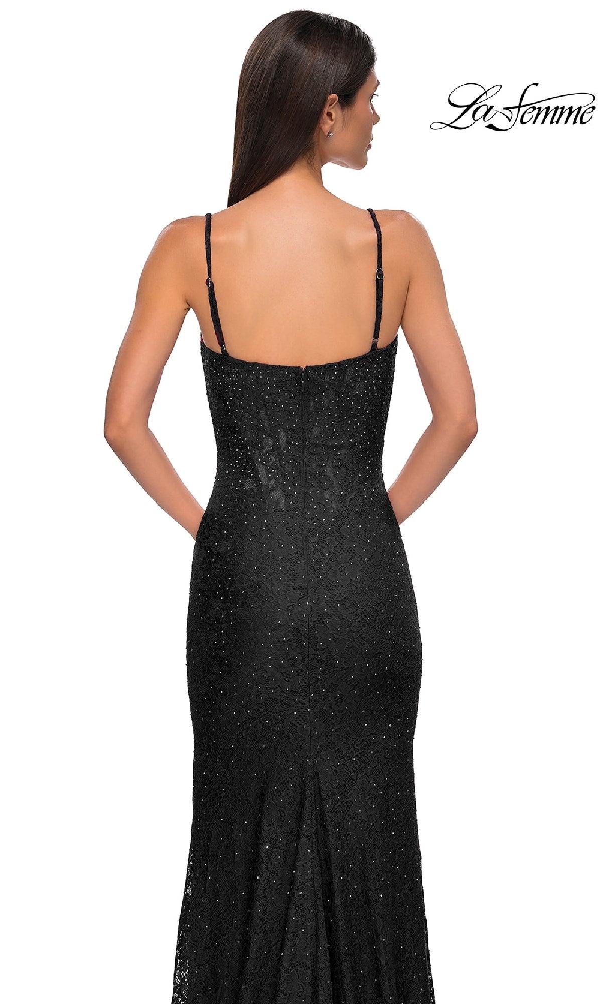 A woman with straight brown hair models the La Femme 32933 Long Beaded-Lace Prom Dress, a sleeveless black floor-length gown. Shown from the back on a white background, the La Femme logo appears in the top right corner.