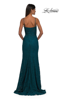 A woman faces away, wearing the Long Beaded-Lace Prom Dress La Femme 32933—a floor-length, teal gown with thin straps and a fitted silhouette.