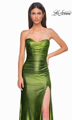 A woman models the Strapless Long Metallic Prom Dress: La Femme 32946 in green with a ruched bodice and high slit, standing against a white backdrop. The "La Femme" logo is displayed in the top right corner.