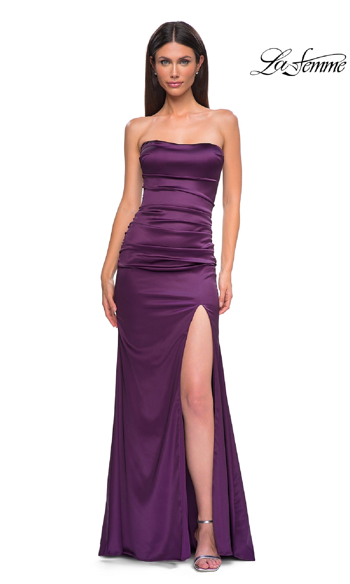 A woman models the Strapless Long Satin Prom Dress: La Femme 32952 in purple, featuring a high thigh slit, standing against a white background with the 