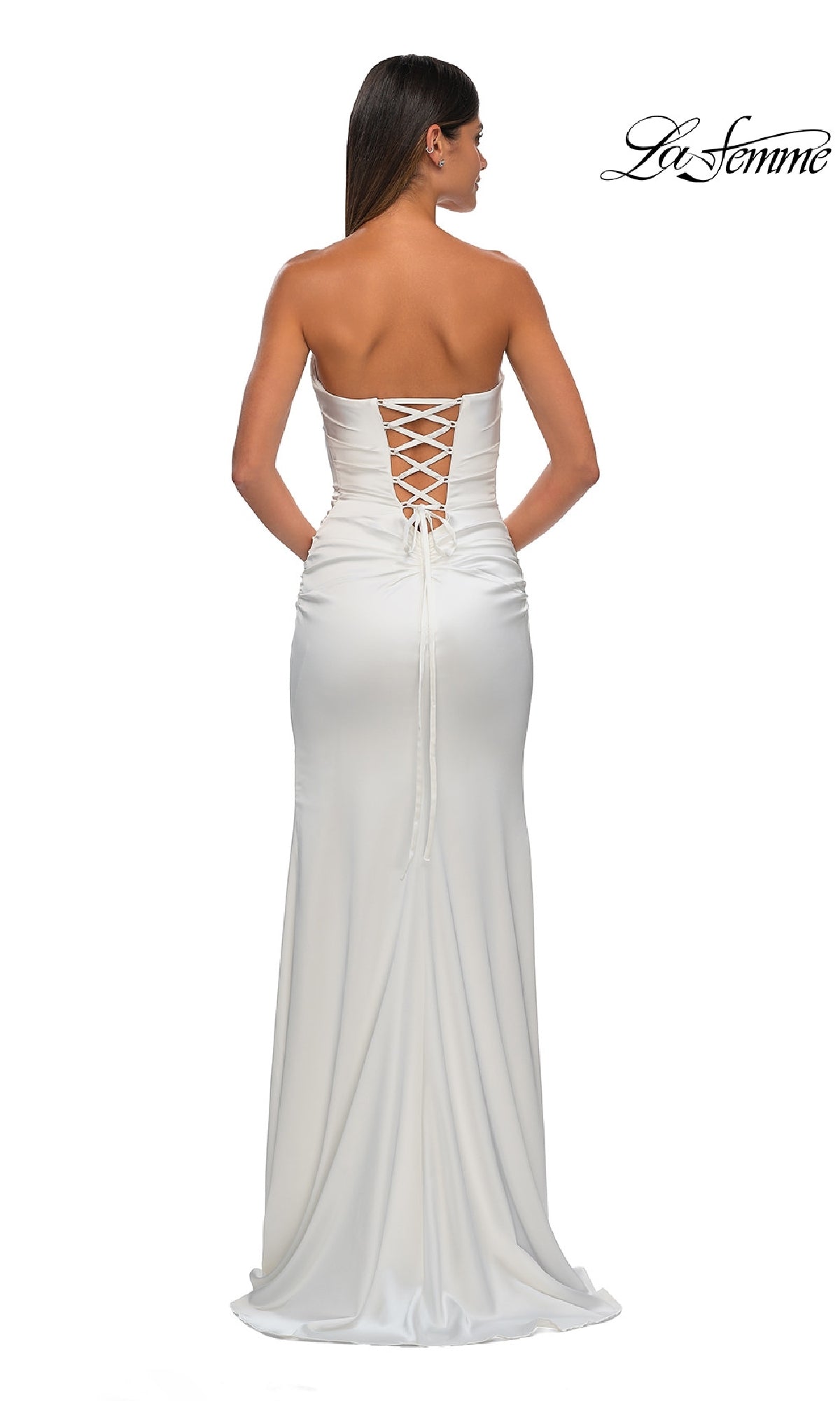 A woman faces away from the camera in the Strapless Long Satin Prom Dress: La Femme 32952, featuring a lace-up back. The La Femme logo appears in the top right corner, showcasing this elegant formal satin gown.