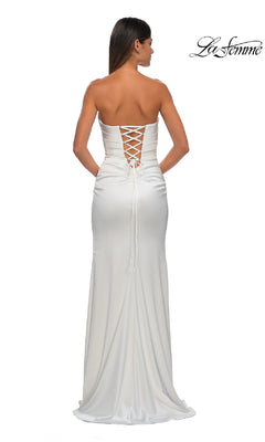 A woman faces away from the camera in the Strapless Long Satin Prom Dress: La Femme 32952, featuring a lace-up back. The La Femme logo appears in the top right corner, showcasing this elegant formal satin gown.