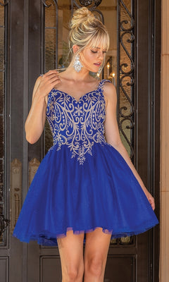A woman wearing the Embroidered-Bodice Short Glitter Hoco Dress 3295, featuring a blue lace-up back and intricate silver embroidery, stands before ornate double doors.