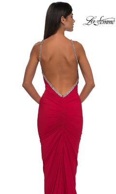 A woman is seen from behind in the La Femme 32970 Backless Ruched Long Prom Dress, featuring a red hue, thin embellished straps, and stylish ruching, set against a plain white background.