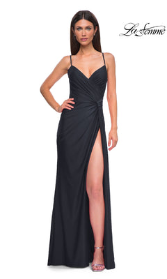 A woman stands facing forward in a sleeveless black Side-Sash Lace-Up Long Prom Dress (La Femme 32977) with a high slit; La Femme logo appears in the top right corner.