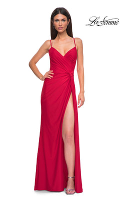 A woman poses against a white background wearing the Side-Sash Lace-Up Long Prom Dress by La Femme (style 32977), a sleeveless, floor-length red gown with a thigh-high slit and ruched bodice. The "La Femme" logo is in the upper right corner.