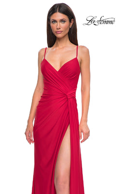 A woman stands against a white background in the sleeveless, floor-length red Side-Sash Lace-Up Long Prom Dress (La Femme 32977) with a thigh-high slit and fitted bodice. The “La Femme” logo appears in the top right corner.