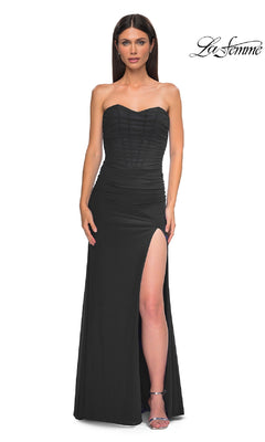 A woman models the La Femme 32990 Lace-Up Strapless Long Prom Dress with a sweetheart neckline, ruched bodice, and thigh-high slit against a white background. The La Femme logo is displayed in the top right.