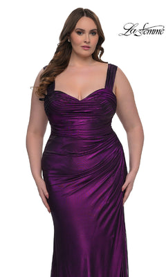 A woman models the plus-size La Femme 32991: a sleeveless fitted metallic purple long prom dress with ruched details, standing against a white background. The "La Femme" logo is visible in the top right corner.