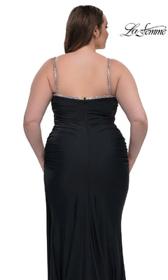 A woman is shown from the back against a white background wearing the Plus-Size Long Prom Dress La Femme 32992—fitted, floor-length, black with thin jeweled straps.