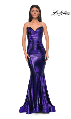 A woman wears the Strapless Long Metallic Prom Dress, La Femme 32995—an elegant purple mermaid gown—standing against a plain white background with the "La Femme" logo in the corner.