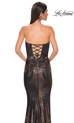 A woman faces away in the Strapless Long Metallic Prom Dress: La Femme 32995, featuring a shimmery finish and lace-up back. The La Femme logo appears in the top right corner.
