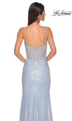 A woman is shown from behind in the Sheer-Corset Long Prom Dress: La Femme 33003, a shimmery light blue gown with thin straps, a sheer beaded back, and subtle ruching at the waist for added elegance.