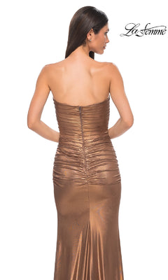 A woman is seen from the back wearing the Metallic Strapless Long Prom Dress: La Femme 33007, featuring ruched detailing, against a plain white background. The "La Femme" logo is in the top right corner.
