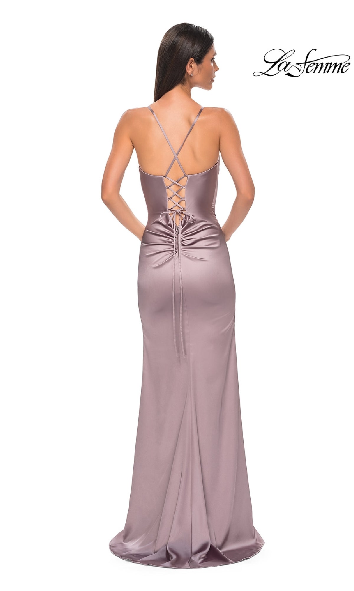 Woman wearing La Femme 33010, a simple mauve satin prom dress with lace-up back, ruched detailing, thin straps, and floor-length hem. Viewed from behind.