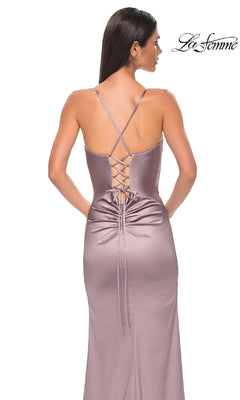 A woman models the Simple Lace-Up Long Prom Dress: La Femme 33010, a mauve satin gown with crisscross lace-up back and ruched detailing, standing against a white background. The La Femme logo appears in the top right corner.