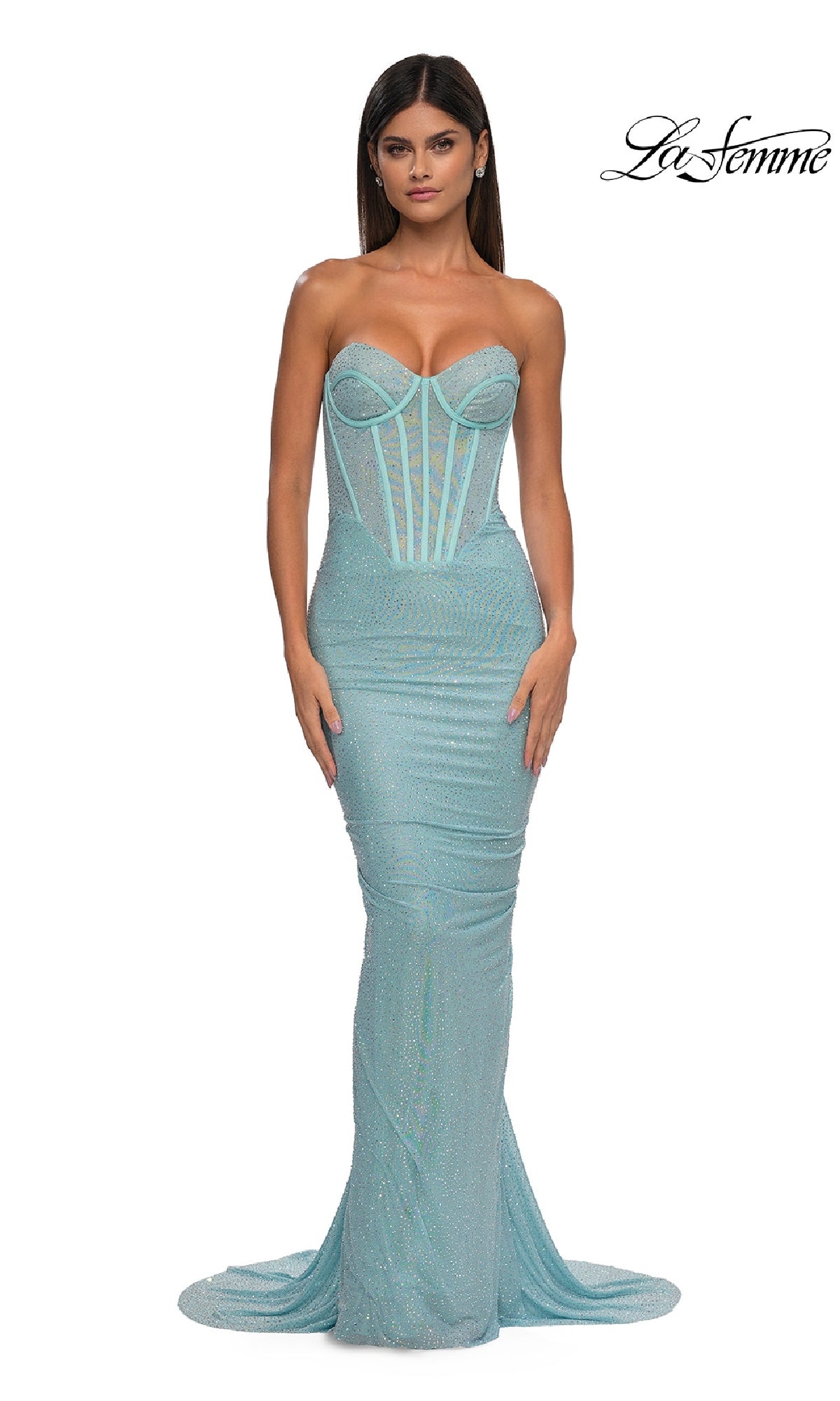 A woman wears the Strapless Beaded Long Prom Gown, La Femme 33019, in light blue with a corset-style bodice and floor-length mermaid skirt. The 