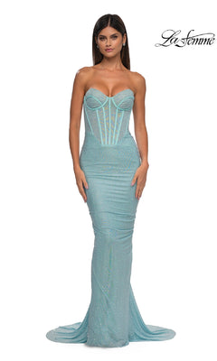 A woman wears the Strapless Beaded Long Prom Gown, La Femme 33019, in light blue with a corset-style bodice and floor-length mermaid skirt. The "La Femme" logo appears in the top right corner.