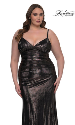 A woman models the Plus-Size Long Metallic Prom Dress: La Femme 33020, featuring ruched details and a deep neckline, in front of a white background. The "La Femme" logo appears in the top right corner.