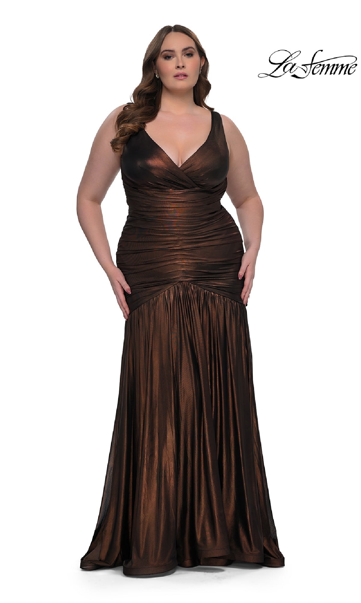 A woman models the Long Plus-Size Prom Dress: La Femme 33021, a sleeveless metallic bronze gown, standing against a plain white background with the 
