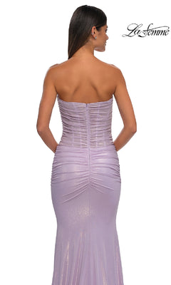 A woman is seen from behind in the Strapless Long Tube Prom Dress: La Femme 33033, featuring a corset-style bodice, ruched details, and a metallic finish for a fitted silhouette. The "La Femme 33033" logo appears in the top right corner.