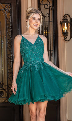 A woman stands outside in the Lace-Up Short Babydoll Homecoming Dress 3303, a sleeveless emerald green A-line party dress with a fitted beaded corset bodice and a fun tulle skirt.