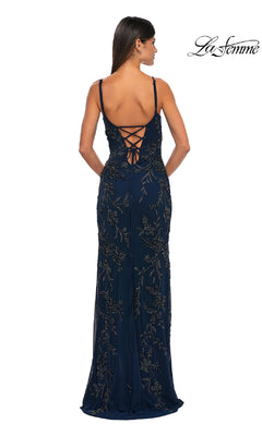 A woman wears the La Femme 33054 Lace-Up Long Beaded Prom Dress in dark blue, featuring floral embellishments and a lace-up back, as she faces away from the camera. The “La Femme” logo is visible in the top right corner.