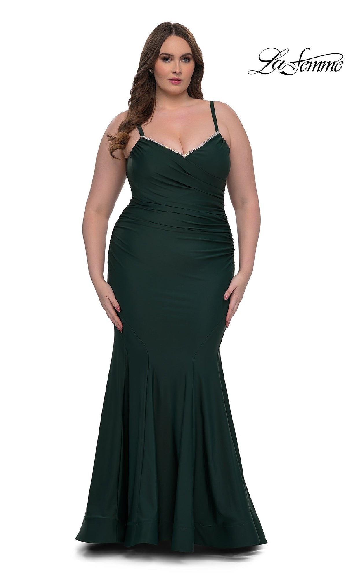 A woman models the Plus-Size Floor-Length Prom Dress: La Femme 33057—an elegant, dark green fitted gown with thin straps—standing against a white background. 
