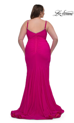 A woman in the La Femme 33057 plus-size floor-length prom dress with thin straps is shown from the back, showcasing the elegance of this stunning bright pink gown.