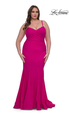 A woman stands against a white background wearing the Plus-Size Floor-Length Prom Dress: La Femme 33057 in bright pink, featuring thin straps and a slight mermaid silhouette. The La Femme logo appears in the top right corner.