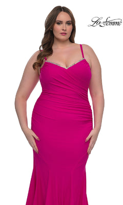 A woman models the Plus-Size Floor-Length Prom Dress: La Femme 33057, a fitted bright pink gown with a beaded neckline and rhinestone accents, against a white background. "La Femme" logo appears in the top right corner.