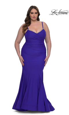 A woman models the Plus-Size Floor-Length Prom Dress: La Femme 33057 in royal blue, featuring thin straps, subtle ruching, a flared hem, and elegant details—perfect for any formal occasion.