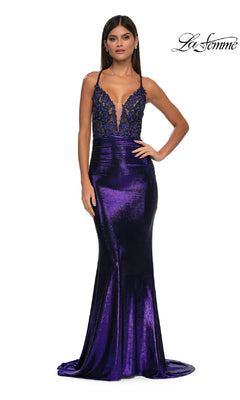 A woman models the La Femme 33059 Strappy Long Metallic Prom Dress in indigo, featuring a fitted shiny skirt and embellished deep V-neck bodice. The La Femme logo is shown in the top right corner.