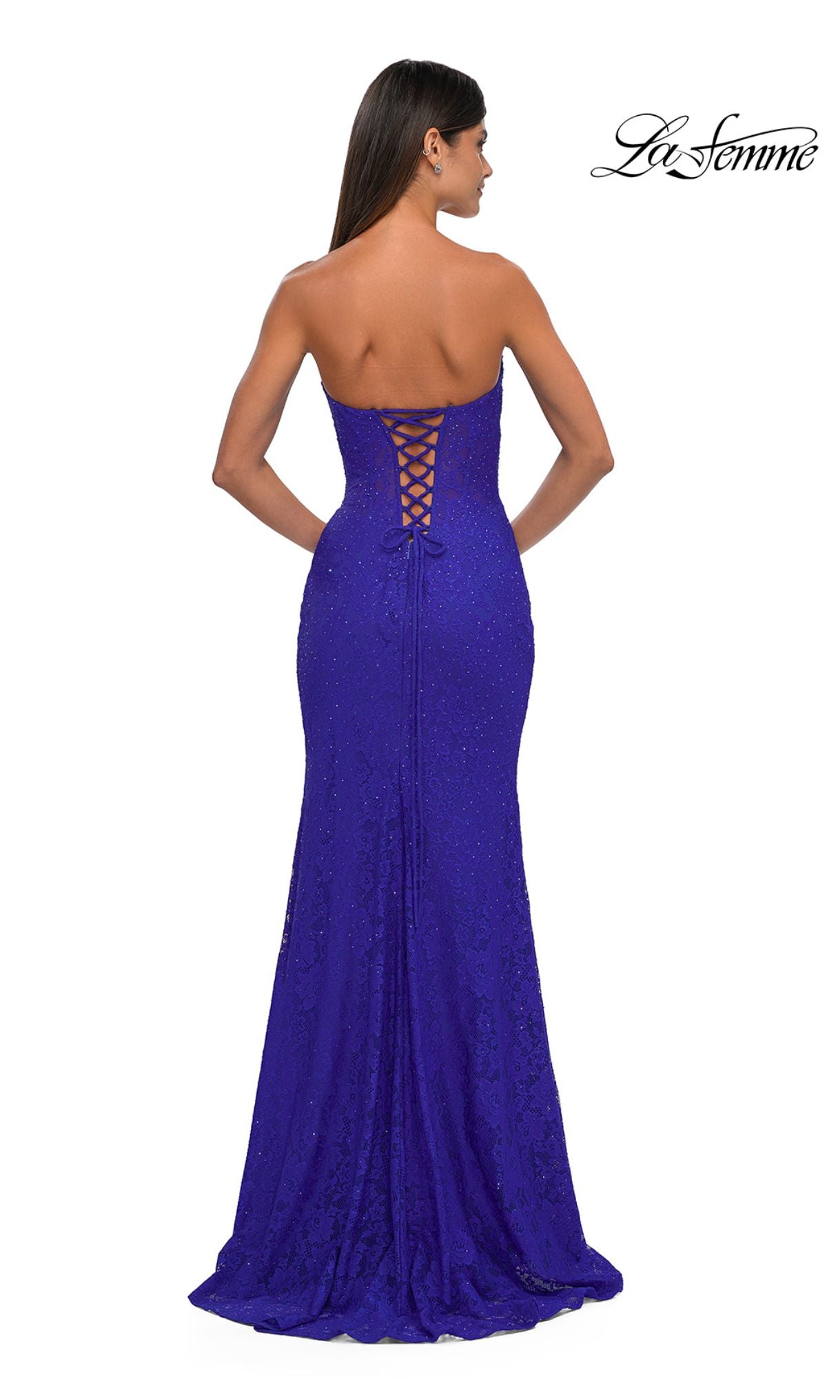 Woman modeling the La Femme 33069 strapless long lace prom dress with a fitted, floor-length silhouette and lace-up back, shown from behind.