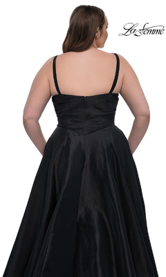 A woman is seen from the back wearing the La Femme 33075, a black, sleeveless, floor-length plus-size prom dress with thin straps and a fitted bodice. The background is white with the "La Femme" logo in the top right corner.