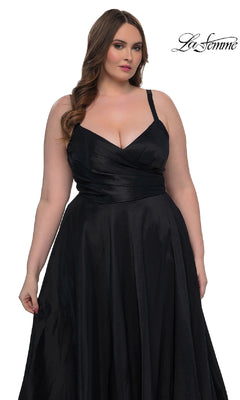 A woman wears the La Femme 33075 long plus-size prom dress, a sleeveless, floor-length black gown with a fitted bodice and elegant A-line skirt. The "La Femme" logo is displayed in the top right corner.