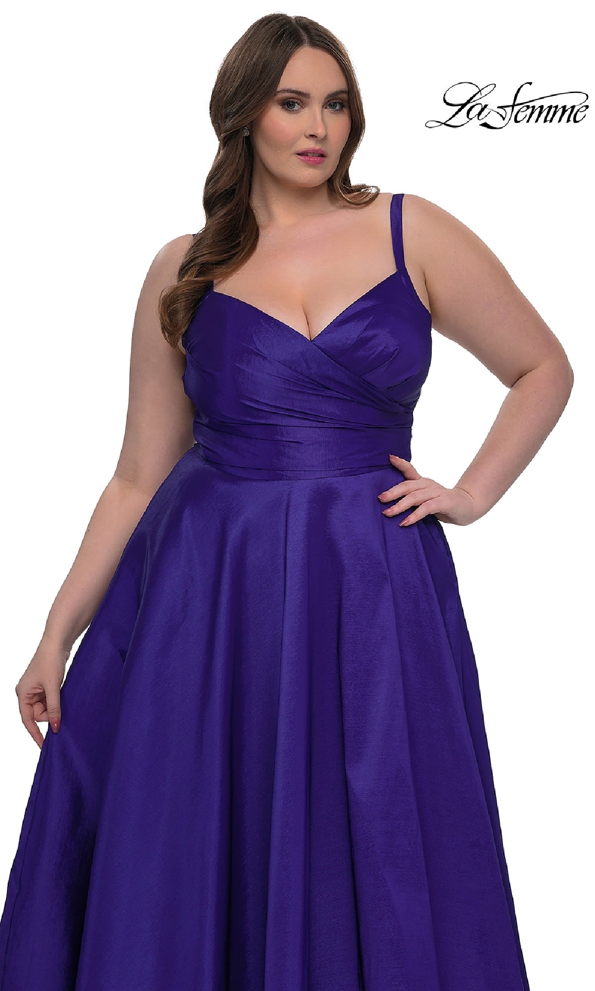 A woman models the La Femme 33075 long plus-size prom dress, featuring a sleeveless fitted bodice and flowing A-line skirt in deep purple, against a white background. 