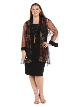 Woman wearing the Plus-Size Jacket Party Dress: R&M Richards 3312W—a semi-formal dress with a sheer floral kimono-style jacket—paired with a long necklace and beige sandals, smiling against a white background.