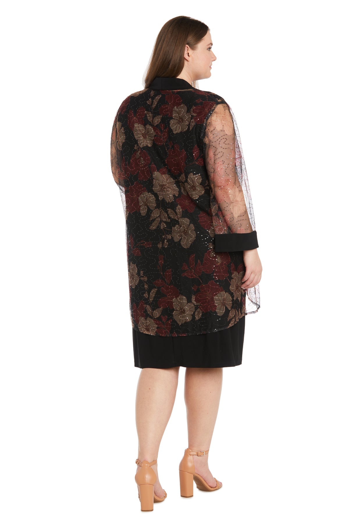 A woman, seen from behind, wears the R&M Richards 3312W Plus-Size Jacket Party Dress featuring a black sheer floral overlay and nude heels against a white background.