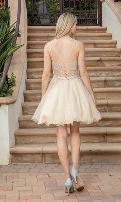 A woman stands on steps, facing away, wearing the Lace-Up-Back Short Babydoll Homecoming Dress 3315. The light beige, sleeveless dress with lace details pairs perfectly with sparkly high heels for special occasions.