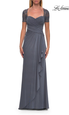 A woman models the “Short Sleeve Long Formal Dress: La Femme 33161” in slate, featuring a floor-length silhouette, ruched bodice, sweetheart neckline, lace short sleeves, and draped side detailing. The background is white with the “La Femme” logo in the top right corner.