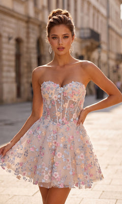 A woman stands on a city street wearing the La Femme 33284 short homecoming dress in nude, featuring a strapless fit-and-flare silhouette with floral embroidered accents and sheer details, paired with drop earrings—a chic choice for anyone looking for a sophisticated nude homecoming dress.