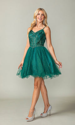 A woman models the Sheer-Corset Short Babydoll Homecoming Dress 3337, showcasing its fitted sequin bodice and tulle skirt, paired with silver high heels, set against a plain light background.