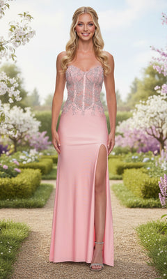 A woman stands outdoors in the La Femme 33398 long prom dress in baby pink, featuring a lace corset bodice and thigh-high slit, surrounded by blooming trees and manicured hedges.