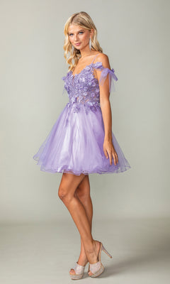 A woman stands against a plain background wearing the Sheer-Corset Short Babydoll Hoco Dress 3339, a light purple, off-the-shoulder, semi-formal A-line dress with floral appliqué details and sparkly high heels.