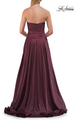 A woman shown elegantly from the back wearing the Strapless Sweetheart Prom Gown: La Femme 33417—a floor-length, deep burgundy formal dress featuring a ruched bodice and flowing skirt with a strapless sweetheart neckline.