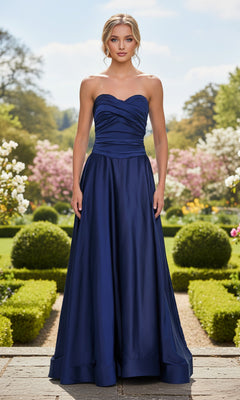 A woman in the Strapless Sweetheart Prom Gown: La Femme 33417 stands in a formal garden, framed by trimmed hedges and blooming flowers.