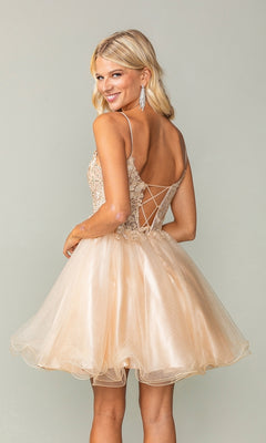Smiling woman in the Lace-Up Short Butterfly Homecoming Dress 3341, featuring a light gold color, spaghetti straps, a lace-up back, and butterfly details.